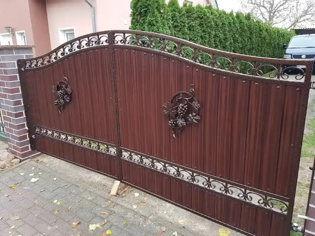 Braunes Metalltor mit dekorativen Schmiedeelementen